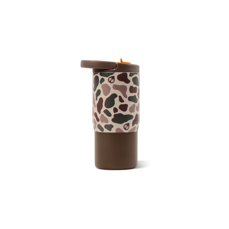 A travel tumbler with a brown base and lid, featuring a beige sleeve with a dark brown and green camouflage pattern and a small paw print logo.