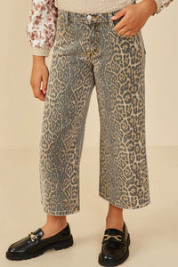 Person wearing leopard print pants with a plain background