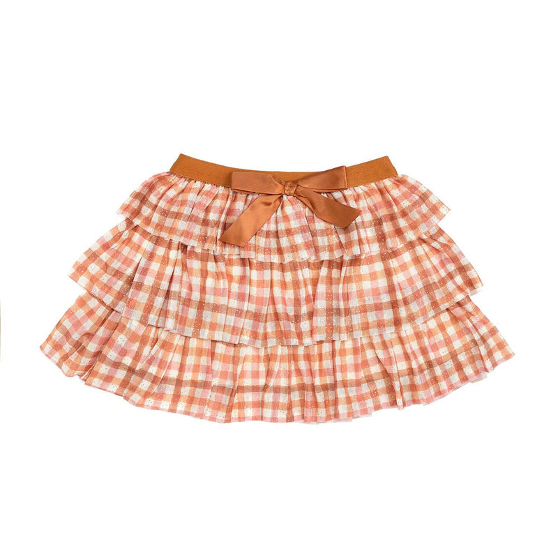 A plaid tiered tutu skirt in blush, cream, and caramel with a burnt orange waistband and satin bow.